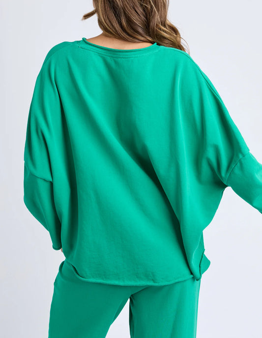 Back view of the Elm Gab Long Sleeve Sweat with raw‑edge hem detailing.