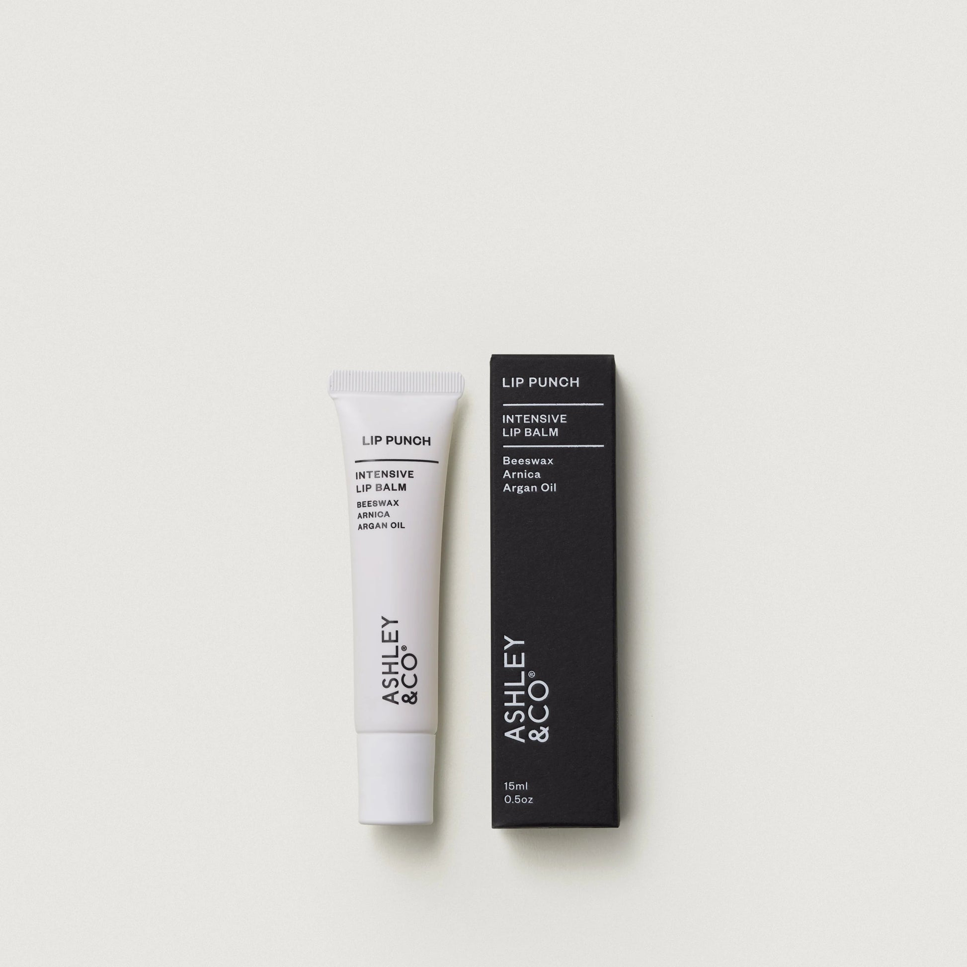 Lip balm and packaging with 'Ashley & Co' branding on a white background