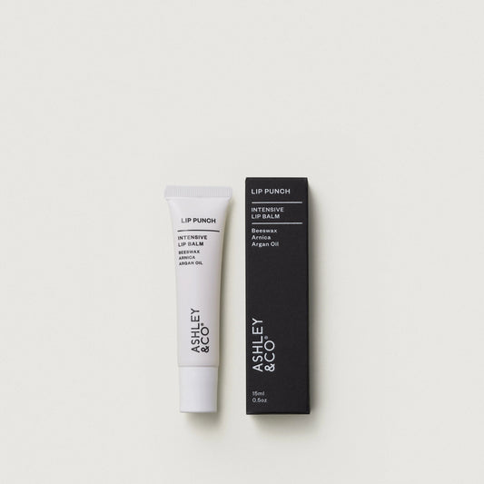 Lip balm and packaging with 'Ashley & Co' branding on a white background