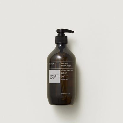 Brown bottle with pump and 'ASHLEY & CO' label on a light gray background
