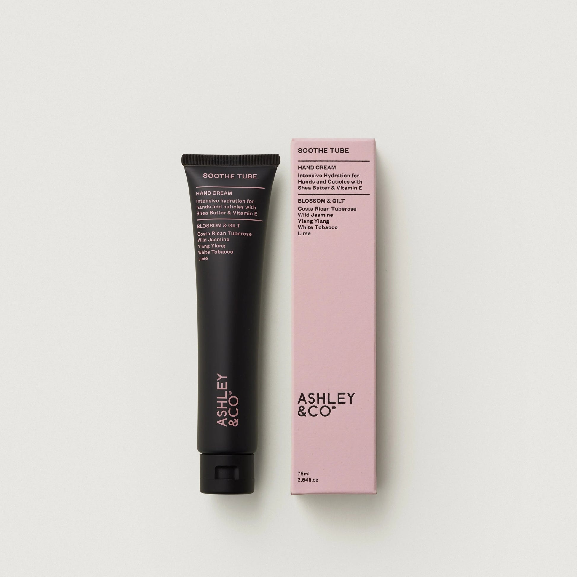 Hand cream tube and packaging with 'Ashley & Co' branding on a light gray background