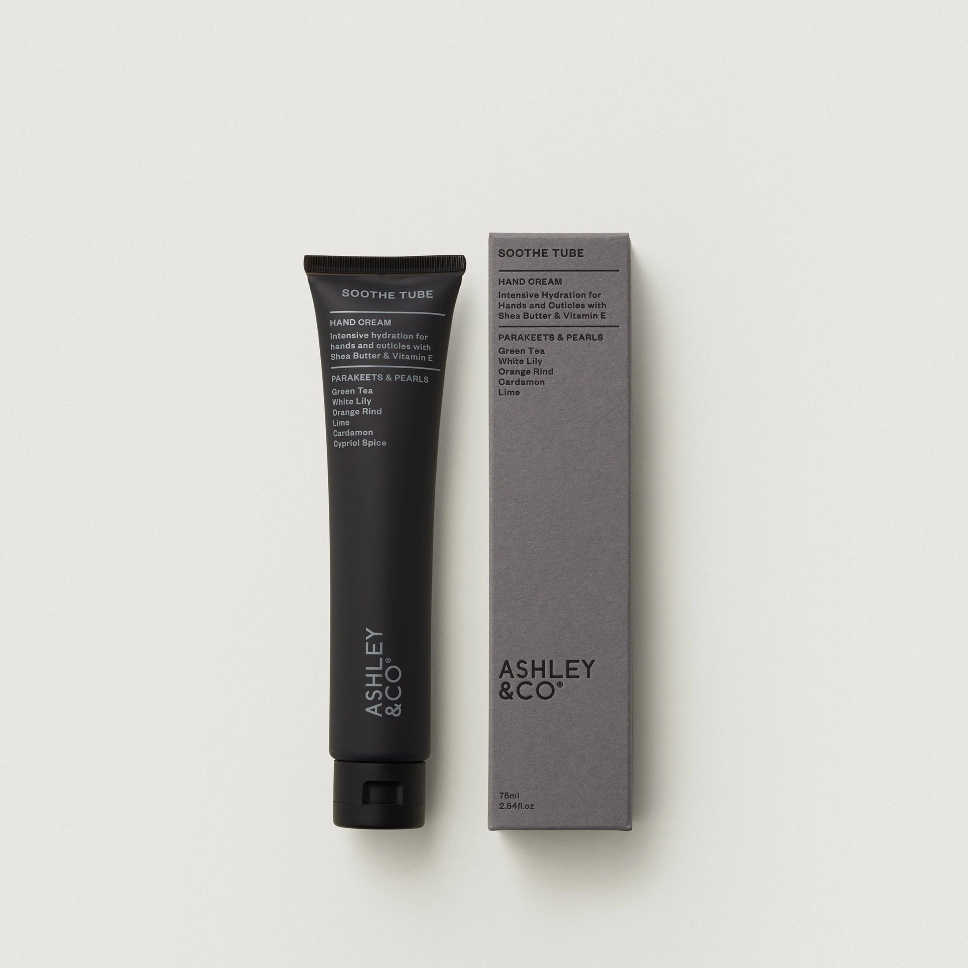 Hand cream tube and packaging with 'Ashley & Co' branding on a light gray background