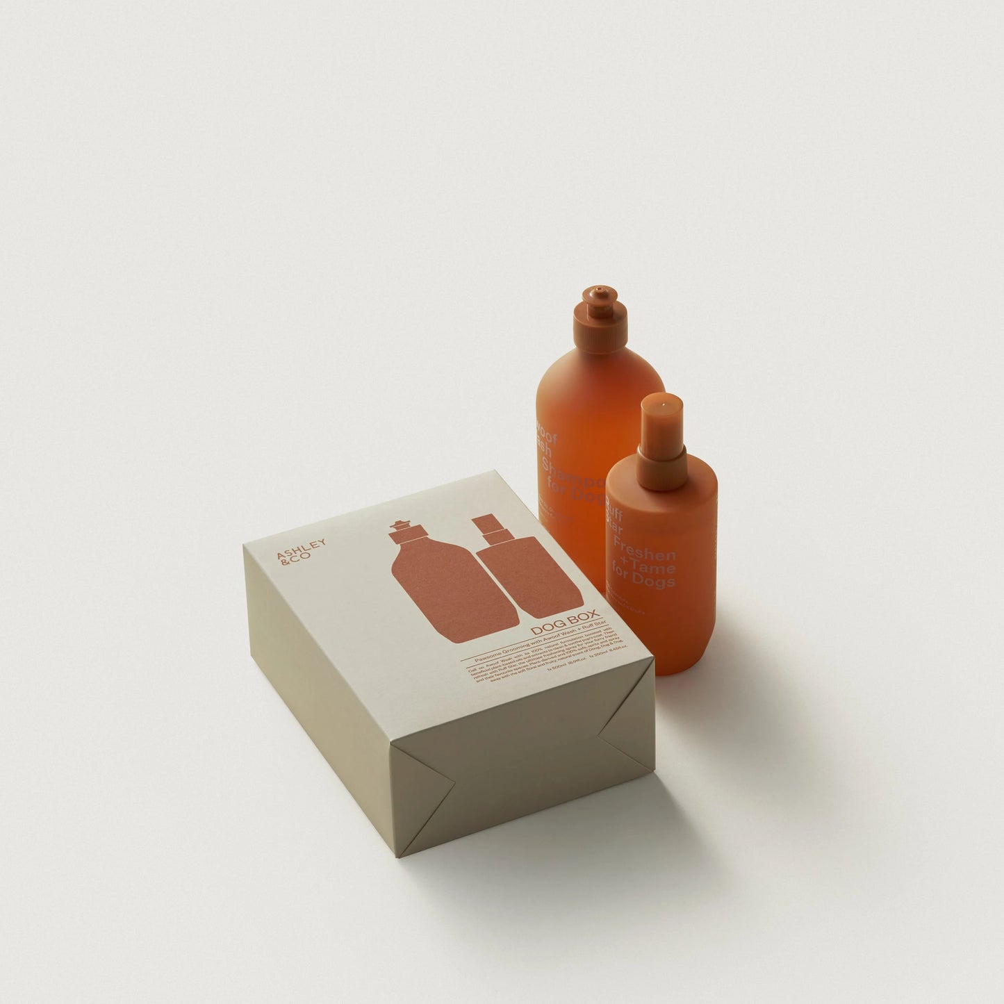 Ashley & Co Two orange bottles and their packaging on a white background