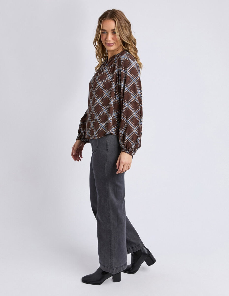 Side angle of the Foxwood Edison Check Top showing drapey fit and sleeve shape.


