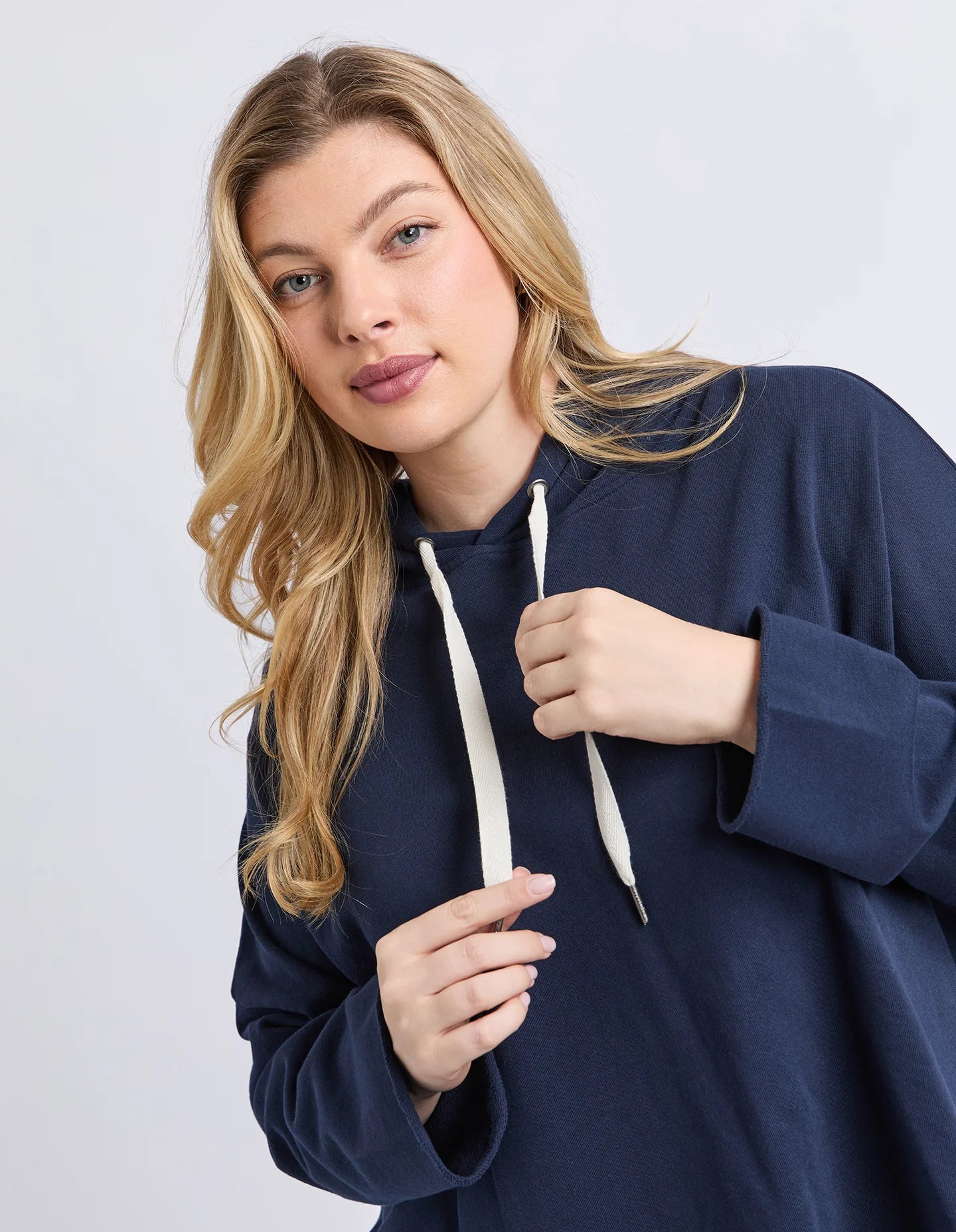 Women’s navy hoodie with raw‑edge finish — front angle