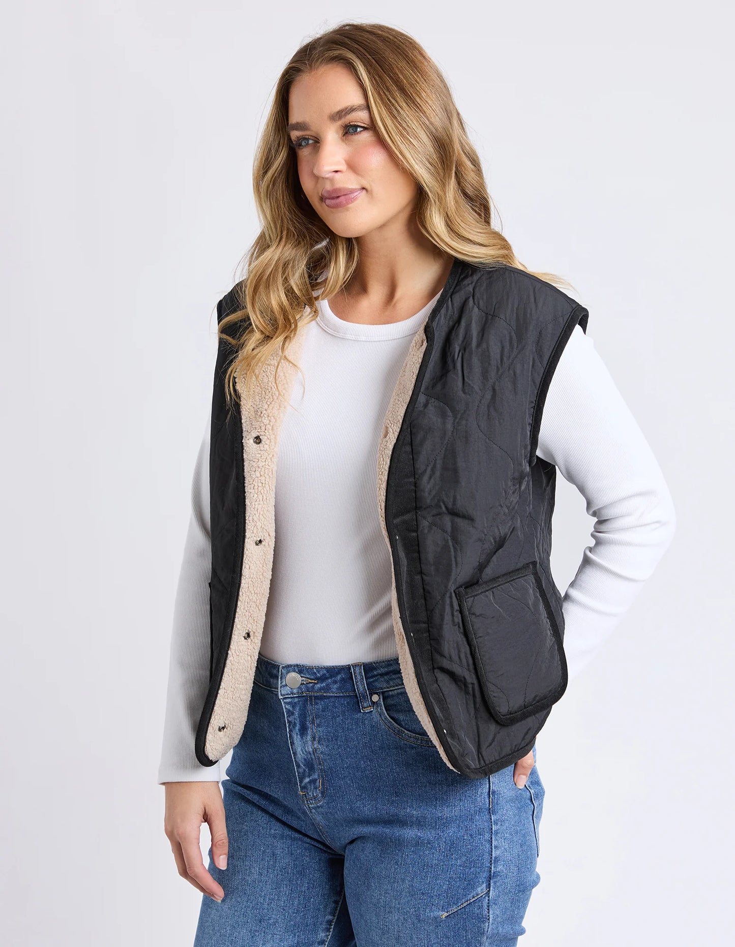 Front view of the Foxwood Alberta Vest in Black showing quilted body and snap opening.