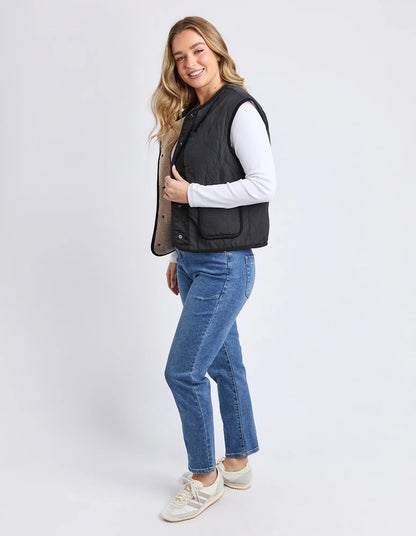 Side angle of the Alberta Vest showing relaxed fit and layering style.

