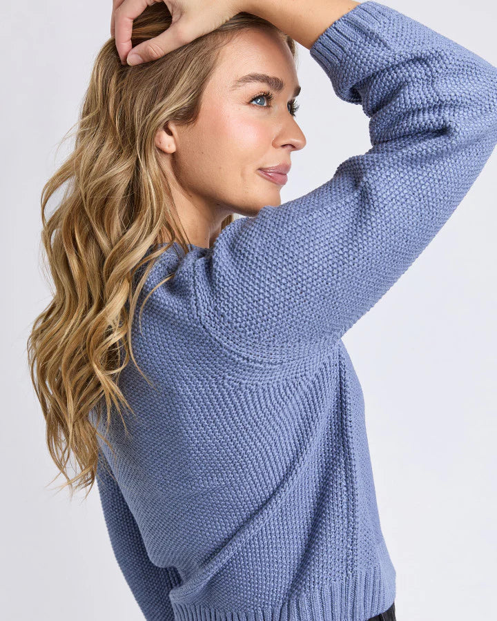 Close‑up of Country Blue cotton knit texture and rib detailing.

