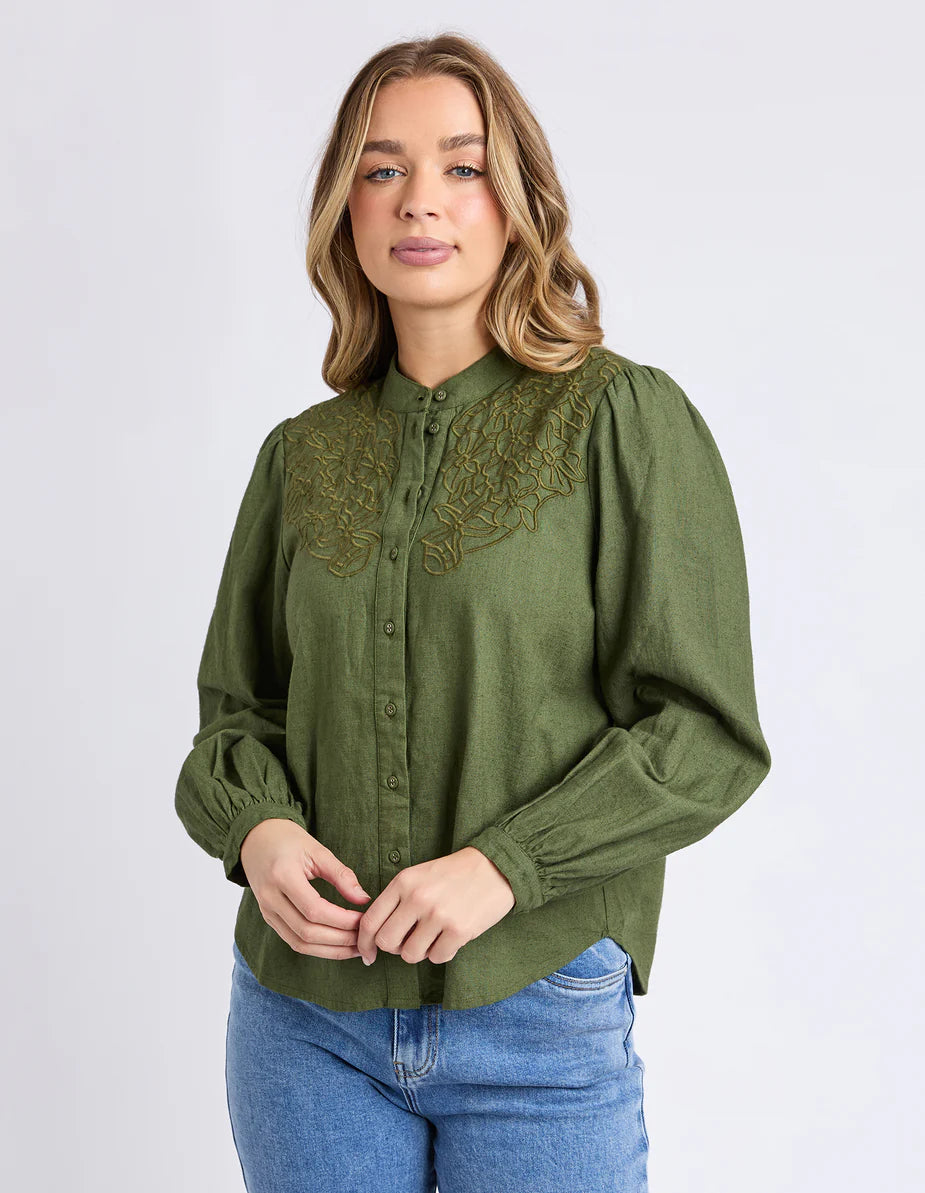 Front view of the Foxwood Eleanor Top in Winter Moss showing embroidery and puff sleeves.

