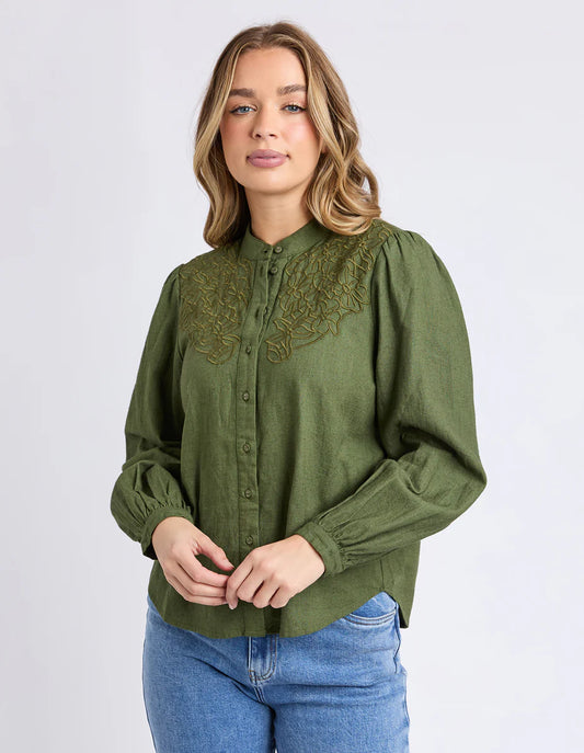 Front view of the Foxwood Eleanor Top in Winter Moss showing embroidery and puff sleeves.

