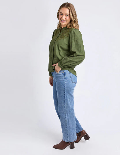 Side angle of the Winter Moss Eleanor Top showing gathered sleeves and high neckline.

